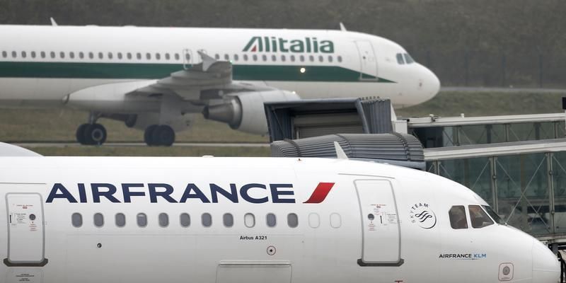 An Alitalia plane passes an Air France plane on the tarmac of Charles de Gaulles International Airport in Roissy near Paris, January 8, 2013 Reuters pic