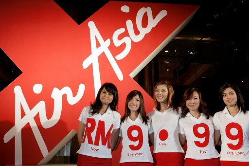 Malaysian budget carrier AirAsia stewardess pose during the launch of AirAsia X in Kuala Lumpur on January 5, 2007.u00e2u20acu201dAFP file pic
