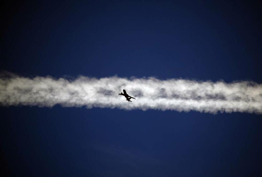 An aeroplane flies underneath the jet stream of another aircraft above the Italian city of Padova September 18, 2013. u00e2u20acu201d Reuters pic