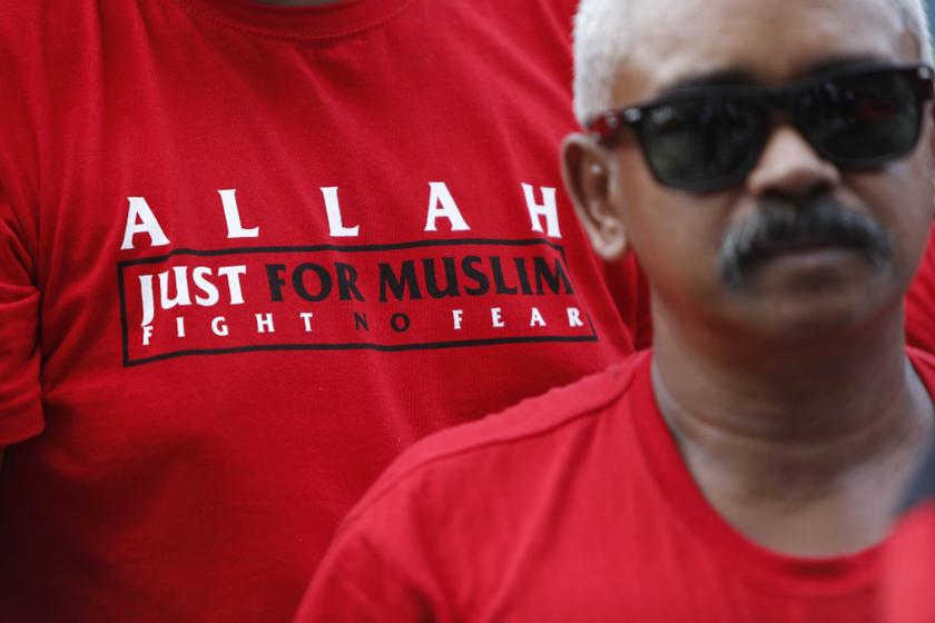 A Muslim demonstrator stands outside Malaysiau00e2u20acu2122s Court of Appeal, along with others, in Putrajaya, outside Kuala Lumpur October 14, 2013. u00e2u20acu201d Reuters pic