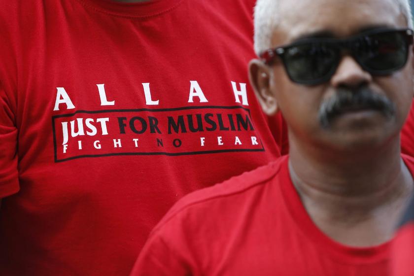 A Muslim demonstrator stands outside Malaysiau00e2u20acu2122s Court of Appeal, along with others, in Putrajaya, outside Kuala Lumpur October 14, 2013. u00e2u20acu201d Reuters pic