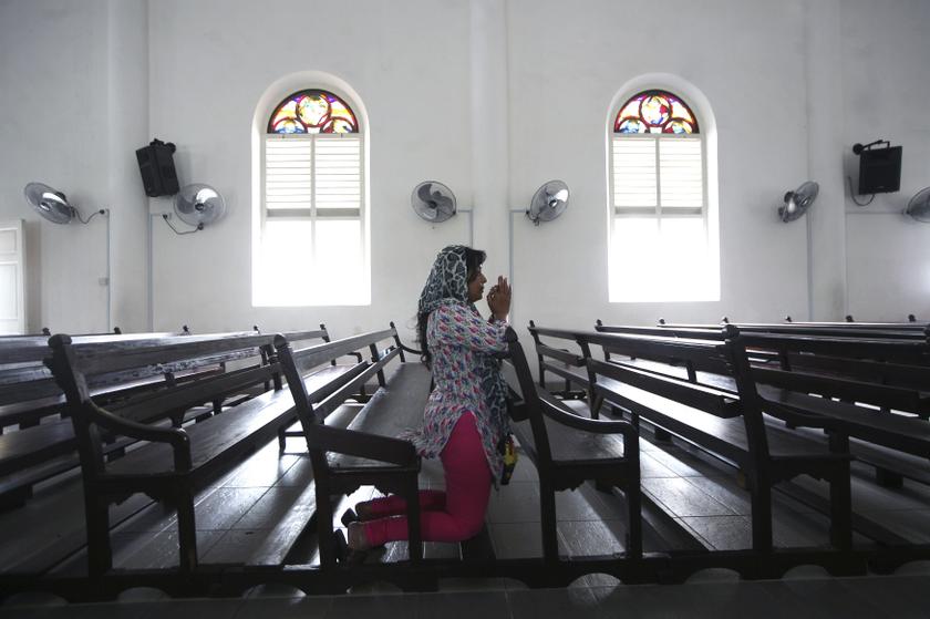 A woman prays inside the church of Our Lady of Lourdes at Klang, outside Kuala Lumpur January 12, 2014. u00e2u20acu201du00c2u00a0Reuters pic