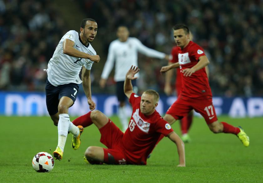England's Andros Townsend (left) goes past Poland's Kamil Glik (centre) and Slawomir Peszko during their 2014 World Cup qualifying match at Wembley Stadium in London October 15, 2013.