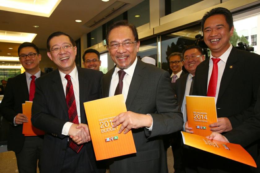 Datuk Seri Anwar Ibrahim shaking hands with Lim Guan Eng while holding a copy of Pakatan Rakyatu00e2u20acu2122s alternative Budget 2014 in Parliament in Kuala Lumpur October 25, 2013. u00e2u20acu201d Picture by Saw Siow Feng