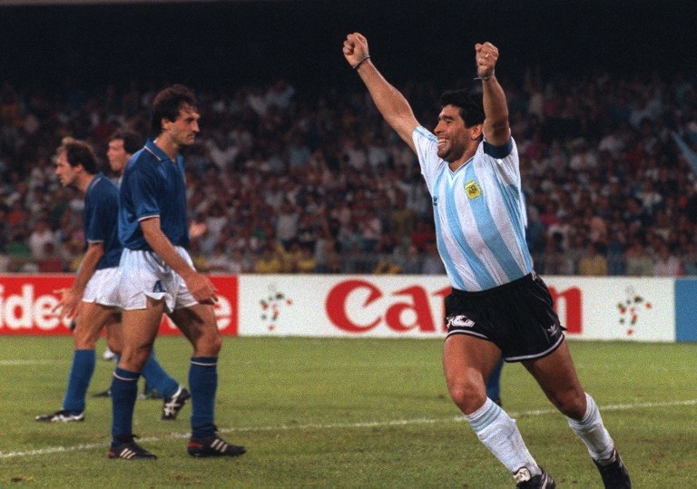 Argentinian forward Diego Maradona celebrates after teammate Claudio Caniggia (not pictured) tied the score at one during the World Cup semifinal match between Italy and Argentina July 3, 1990 in Naples. u00e2u20acu201d AFP pic