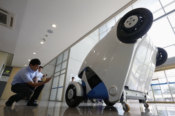 A visitor takes photographs of Armadillo-T, a foldable electric vehicle, at the Korea Advanced Institute of Science and Technology (KAIST) in Daejeon, south of Seoul September 2, 2013. u00e2u20acu201d Reuters pic