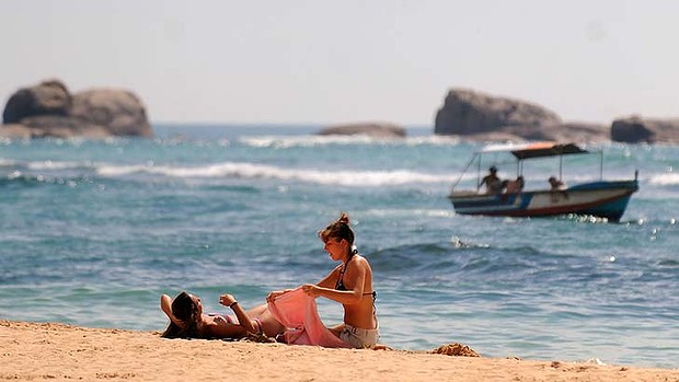 Tourists rest on a beach of Sri Lanka's southern coastal town of Hikkaduwa. u00e2u20acu201d AFP pic