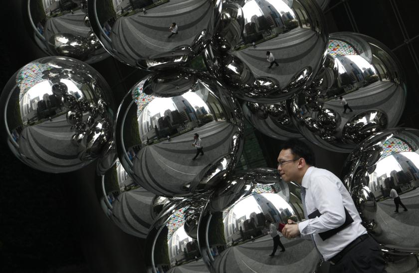 An office worker passes an art installation by British artist Anish Kapoor at the central business district in Singapore November 28, 2013. u00e2u20acu201d Reuters pic