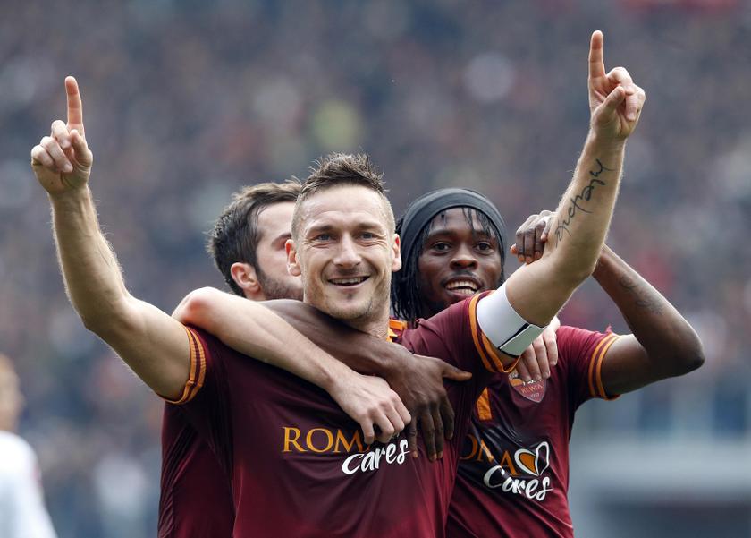 AS Roma's Francesco Totti (C) celebrates with his team mate Gervinho (R) after scoring against Genoa in their Serie A soccer match at Olympic stadium in Rome, January 12, 2014. u00e2u20acu201d Reuters pic