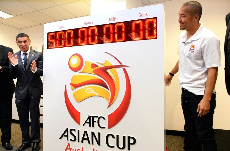 Iraq's Ali Abbas (left) and Japan's Shinji Ono (righ) start the countdown clock for the AFC Asian Cup as it is announced Australian football captain Lucas Neill will be the Captain Ambassador for AFC Asian Cup Australia 2015, In Sydney on August 17, 2013.