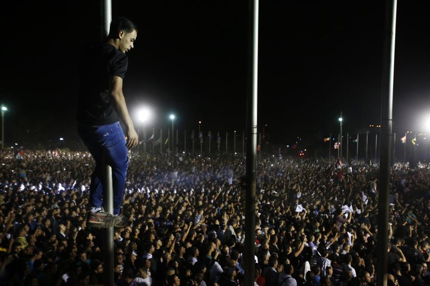 Supporters cheer as 'Arab Idol' Mohammed Assaf performs in the West Bank city of Ramallah July 1, 2013.
