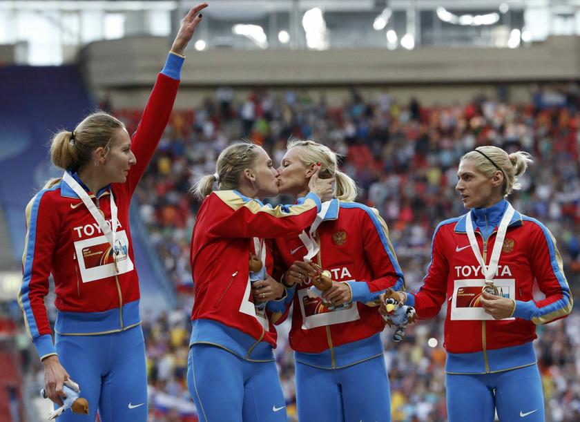 Gold medallists team Russia kiss and celebrate at the women's 4x400 metres relay victory ceremony during the IAAF World Athletics Championships at the Luzhniki stadium in Moscow August 17, 2013. From left: Yulia Gushchina, Kseniya Ryzhova, Tatyana Firova 