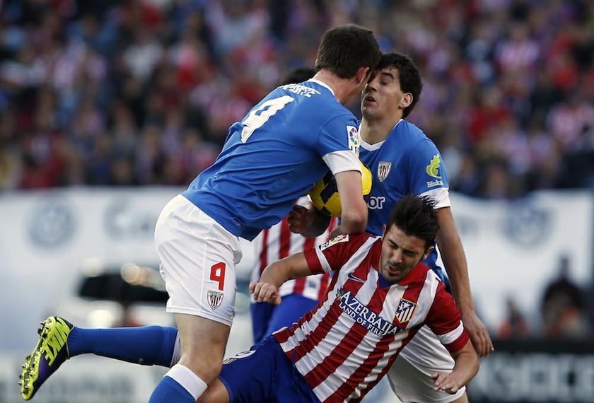 Atletico Madridu00e2u20acu2122s David Villa (centre) collides with Athletic Bilbaou00e2u20acu2122s Aymeric Laporte (left) and Mikel San Jose during their Spanish First Division match at Vicente Calderon stadium in Madrid November 3, 2013. u00e2u20acu201d Reuters pic