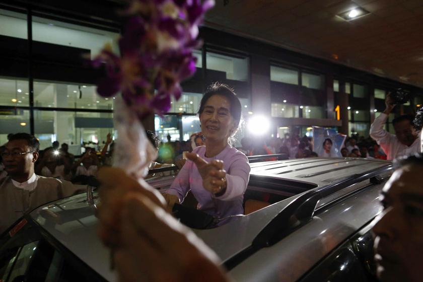 Myanmar's opposition leader Aung San Suu Kyi receives flowers from supporters as she arrives home from a trip to Europe, at Yangon International Airport in Yangon Sept 18, 2013. u00e2u20acu201d Reuters pic