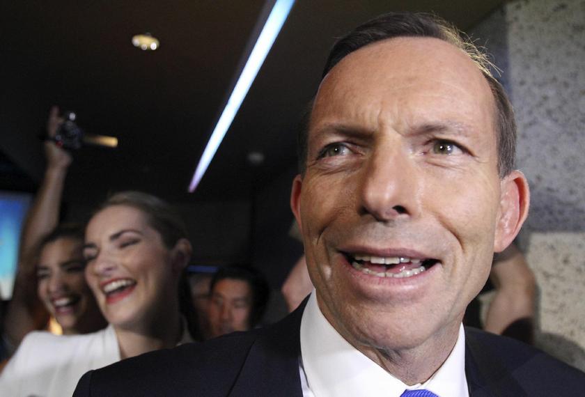 Australia's conservative opposition leader Tony Abbott (R) laughs as he arrives with his daughter Bridget (L) for the official launch of his party's election campaign in Brisbane August 25, 2013