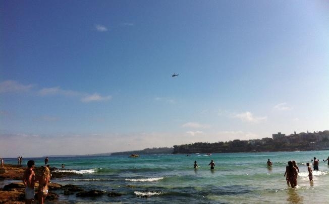 This photo shows swimmers at Sydney's iconic Bondi Beach standing on the edge of the waters after a shark alert forced thousands back to land on January 1, 2013. u00e2u20acu201d AFP pic