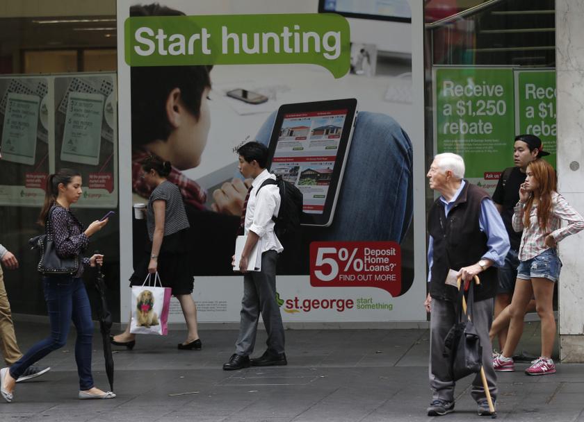 People walk past a bank advertisement for home mortgages in Sydney February 4, 2014. u00e2u20acu201d Reuters pic