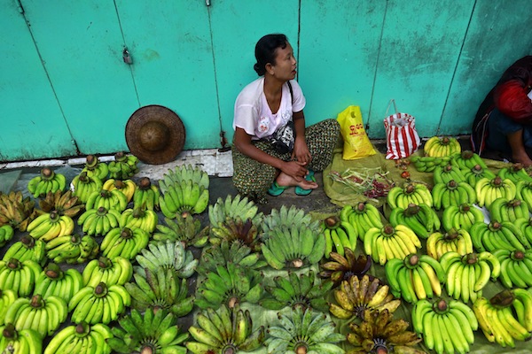 A woman sells bananas at a street-side stall in Yangon. — Reuters pic