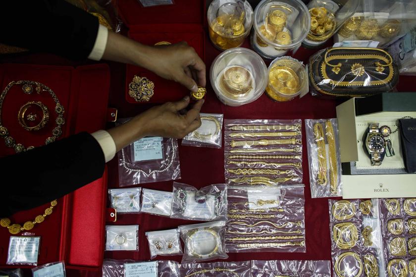 A pawn shop worker prepares jewellery and luxury watch for photographs at Easy Money pawn shop in Bangkok, August 27, 2013. u00e2u20acu201d Reuters pic