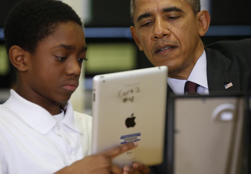 US President Barack Obama talks with a student holding an iPad during a visit to Buck Lodge Middle School in Adelphi, Maryland February 4, 2014. u00e2u20acu201d Reuters pic