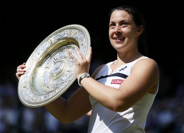 Marion Bartoli of France holds her trophy after defeating Sabine Lisicki of Germany in their womenu00e2u20acu2122s singles final at the Wimbledon Tennis Championships, in London July 6, 2013. u00e2u20acu201d Reuters pic