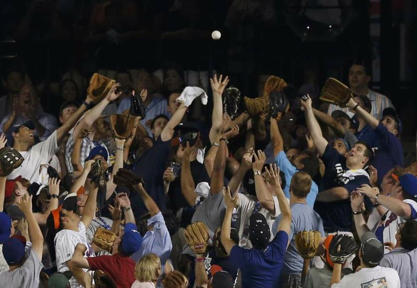 Fans reach up to catch a home run ball off the bat of National League batter David Wright, of the New York Mets during the Major League Baseball All-Star Game Home Run Derby in New York on July 15, 2013. u00e2u20acu201d Reuters pic