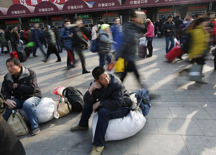 A man sits on his sack outside the Beijing Railway Station, ahead of the Chinese Lunar New Year, January 28, 2014. u00e2u20acu201d Reuters pic