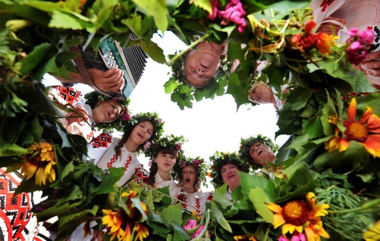 Belarussian women wearing traditional clothes and holding flowers sing in the village of Plastok, some 175km south of Minsk, on June 23, 2013 as part of festivities surrounding the Orthodox u00e2u20acu02dcTrinityu00e2u20acu2122s Dayu00e2u20acu2122 holiday. u00e2u20acu201d AFP pic