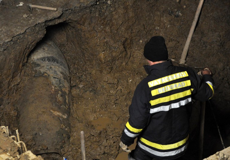 Emergency situations personnel work at the site where an unexploded bomb, of 'great destructive power' dating back to World War II, was found late on December 7, 2013, in downtown Belgrade. u00e2u20acu201d AFP pic