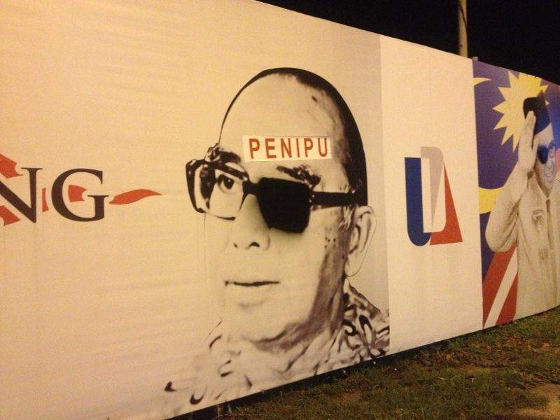 The defaced billboard bearing Tun Razak Hussein’s image. 