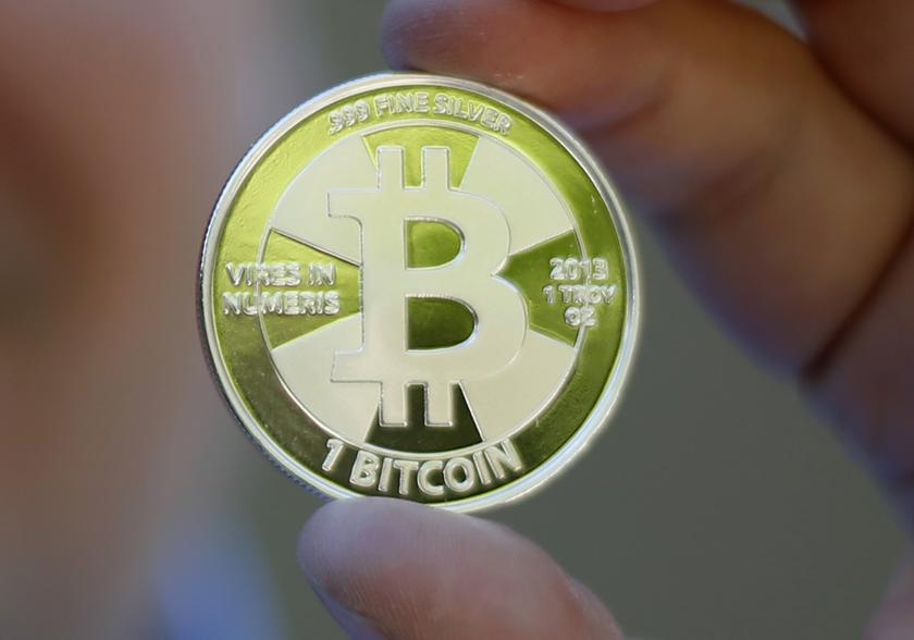 A mockup of a bitcoin, a virtual currency traded worldwide, is held in this photo illustration in Sandy, Utah in this September 17, 2013 file photo. u00e2u20acu201d Reuters pic