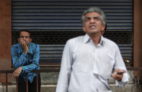 People look at a screen displaying the Sensex on the facade of the Bombay Stock Exchange (BSE) building in Mumbai August 16, 2013. u00e2u20acu201d Reuters pic