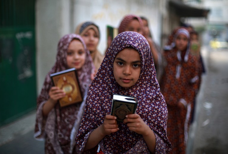 Palestinian girls arrive to read verses from the Koran during a class on how to read the holy book of Islam, at a mosque in Gaza City, on June 9, 2013. u00e2u20acu201c AFP pic