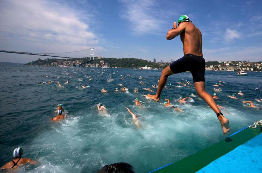 A competitor jumps into the water to swim from Asia to Europe during the annual Bosphorus Cross-Continental swimming competition in Istanbul on July 7, 2013. u00e2u20acu201d Reuters pic
