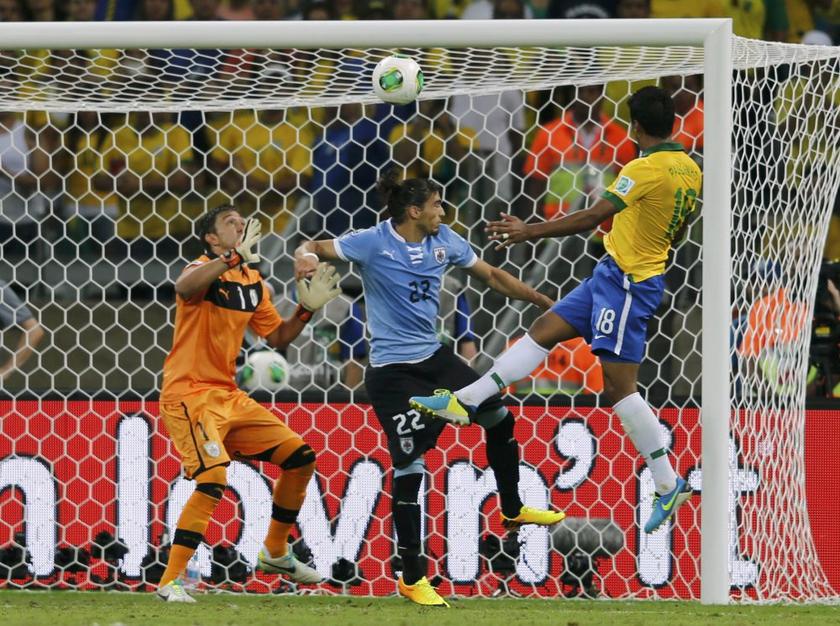 Brazilu00e2u20acu2122s Paulinho (right) heads the ball to score a goal past Uruguayu00e2u20acu2122s Martin Caceres and goalkeeper Fernando Muslera (left) during their Confederations Cup semi-final match in Belo Horizonte on June 26, 2013. u00e2u20acu201d Reuters pic