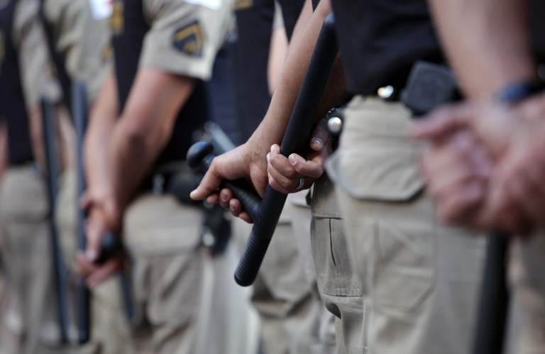 BRAZIL, Belo Horizonte : Brazilian policemen stand guard during a demonstration against the $15 billion being spent on this month's Confederations Cup and the 2014 World Cup, on June 19, 2013, in Belo Horizonte, state of Minas Gerais. Protests initially s