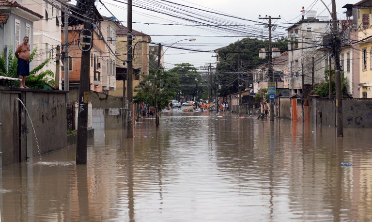 View of a flooded street of a suburb in Rio de Janeiro on December 11, 2013. u00e2u20acu201d AFP pic