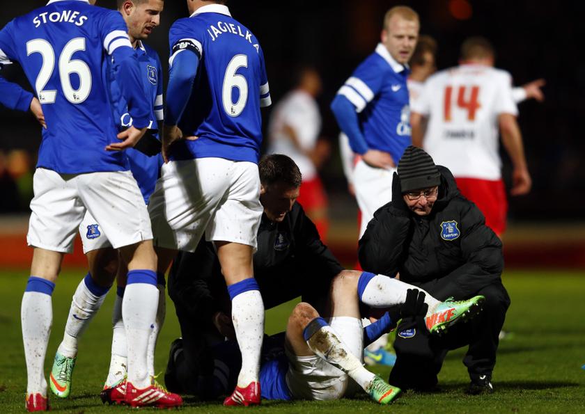 A physiotherapist holds the leg of Evertonu00e2u20acu2122s Bryan Oviedo as he lies with a broken leg during their English FA Cup match against Stevenage at Broadhall Way in Stevenage January 25, 2014. u00e2u20acu2022 Reuters pic