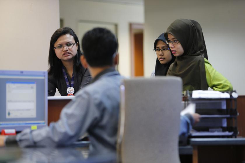 Malaysian government employees work inside the Land Public Transport Commission (SPAD) office in Putrajaya October 9, 2013. u00e2u20acu201du00c2u00a0Reuters pic