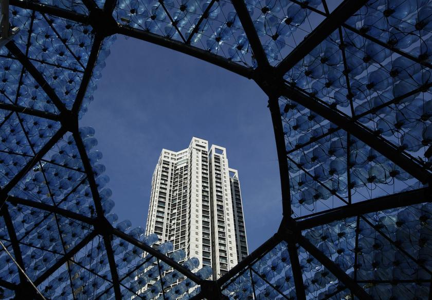 A residential tower is framed from inside a sculpture containing 7,000 recycled plastic water bottles with LED lights at Hong Kong's Victoria Park, Sept 10, 2013.  u00e2u20acu201d Reuters pic