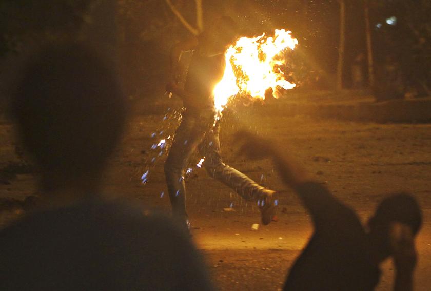 A protester who opposes Egyptian President Mohamed Mursi runs after a Molotov cocktails burn him during their attack of national headquarters of the Muslim Brotherhood in Cairo's Moqattam district June 30, 2013. u00e2u20acu201d Reuters pic
