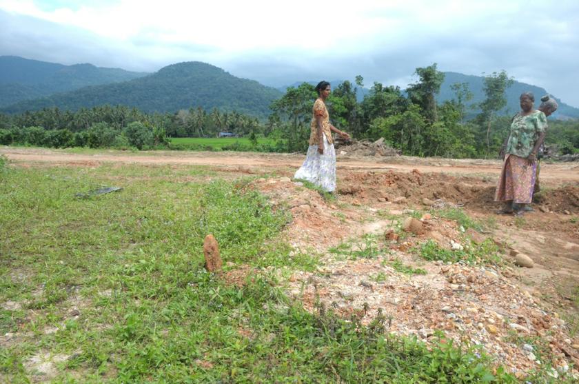 Locals looking around the site where candi number 11 once stood in Lembah Bujang, Kedah, December 2, 2013. u00e2u20acu201d Picture by K.E. Ooi