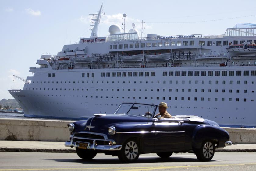 A man drives his convertible car beside the Maltese flagged u00e2u20acu02dcThomson Dreamu00e2u20acu2122 cruiser docked at Havanau00e2u20acu2122s port December 7, 2013. u00e2u20acu201d Reuters pic