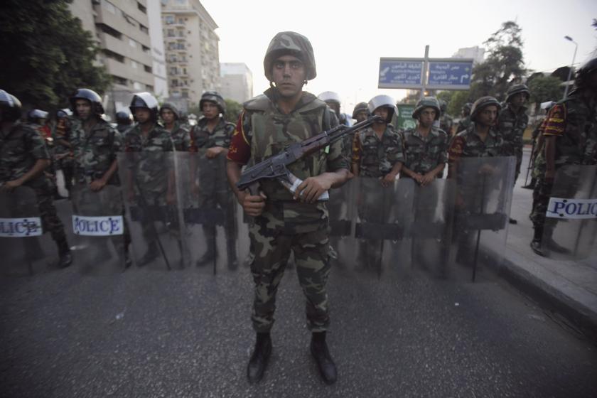 Army soldiers stand guard in front of protesters who are against Egyptian President Mohamed Mursi, near the Republican Guard headquarters in Cairo July 3, 2013. u00e2u20acu201d Reuters pic