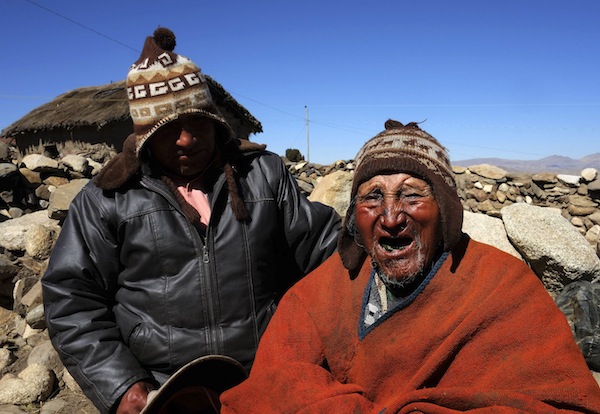 Aymara Indian Carmelo Flores (right) and his son Cecilio joke during a Reuters TV interview in his hometown of Frasquia, 110km north of La Paz, August 16, 2013. u00e2u20acu201d Reuters pic