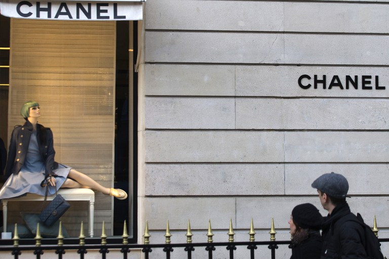 People look at the shop window of a Chanel store, on December 26, 2012 in Paris. — AFP pic