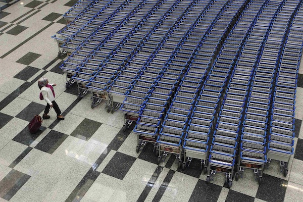 A woman prepares to take a trolley as she arrives at Terminal 3 of Singaporeu00e2u20acu2122s Changi Airport August 20, 2013. u00e2u20acu201d Reuters pic