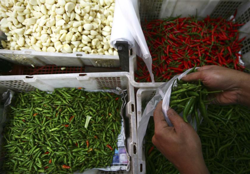 A customer put chillies inside a plastic bag at a wet market in Shah Alam outside Kuala Lumpur January 22, 2014. u00e2u20acu201d Reuters pic