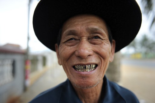 An elderly man laughs outside at a tea house in Chengmai city. — AFP pic