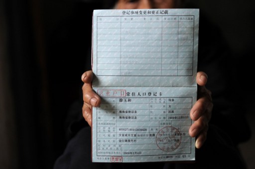 Xu Yuhe, a 103-year-old elderly woman, shows her birth certificate at her home in Chengmai city. u00e2u20acu201d AFP pic 